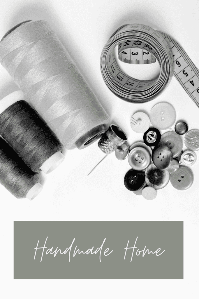 thread, buttons, and sewing tape measure. The words say handmade home.