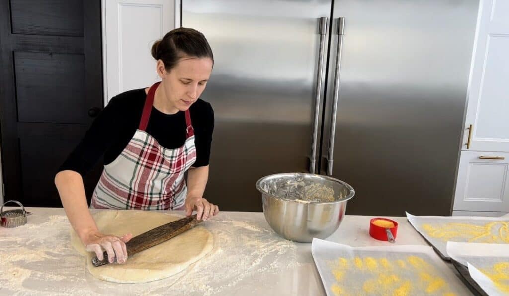 rolling out the dough for sourdough english muffins