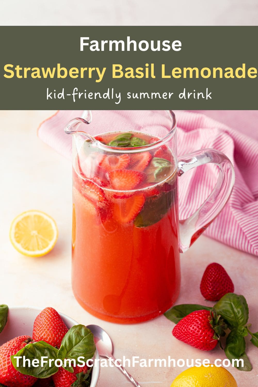 strawberry basil lemonade in a glass pitcher with fresh strawberries on the farmhouse table