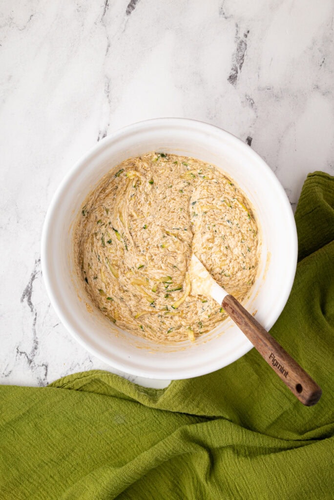 stirring in zucchini in sourdough zucchini bread