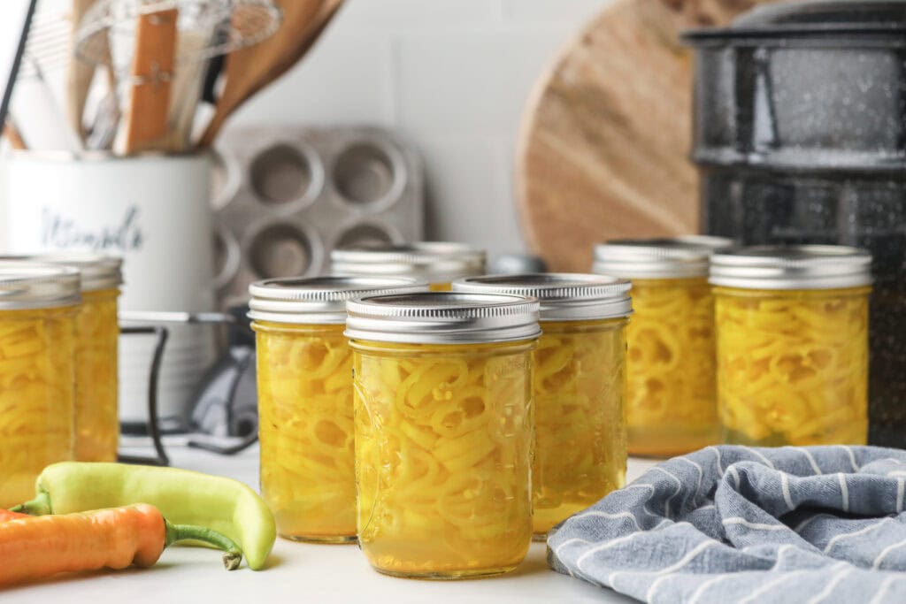 Glass jars of pickled banana pepper rings