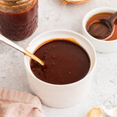 homemade honey bbq sauce in a jar and in a bowl for serving